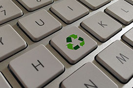 Image shows a special key on a computer keyboard for recycling and waste management.