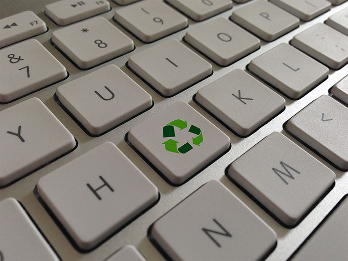 Image shows a special key on a computer keyboard for recycling and waste management.